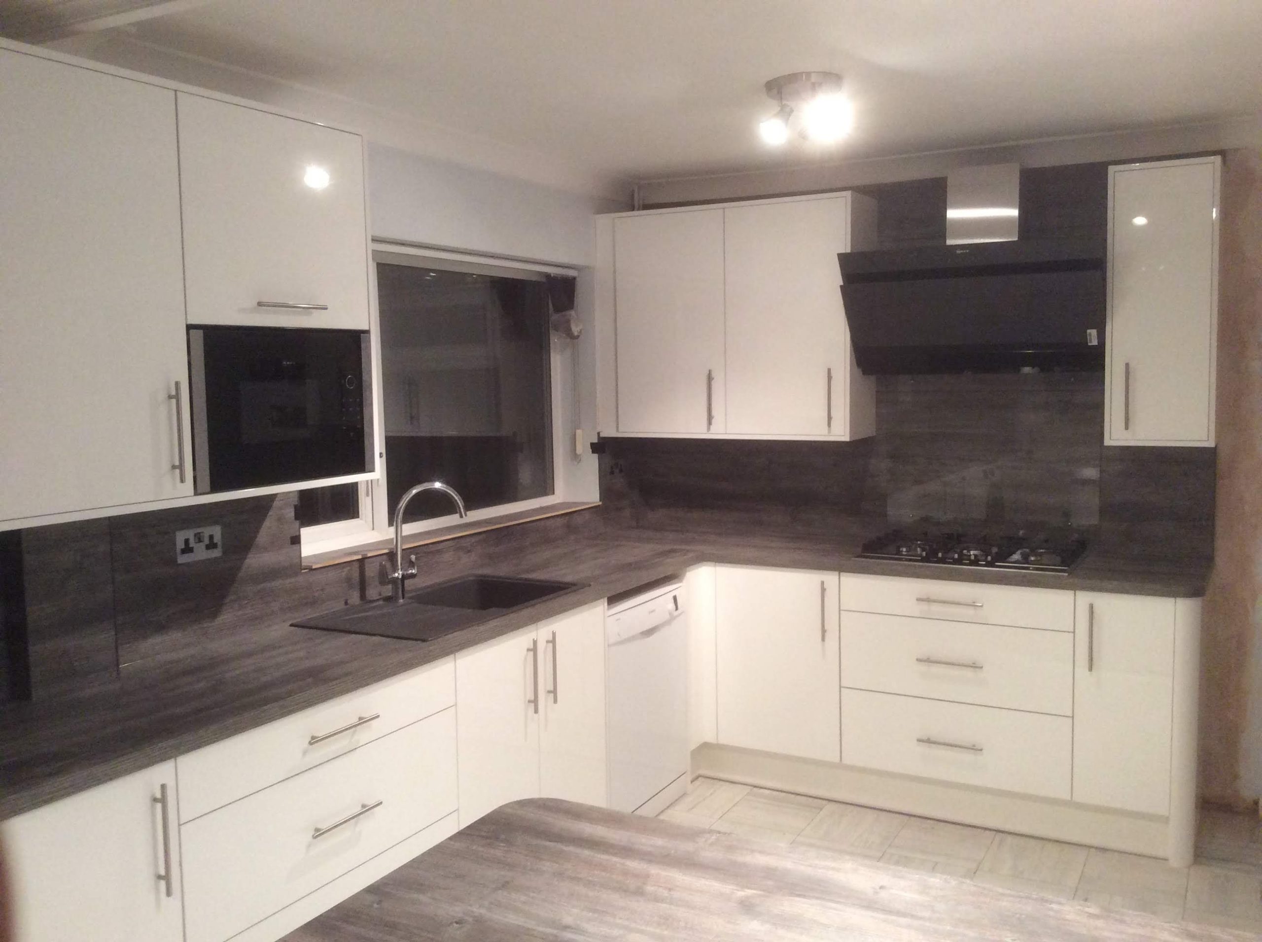 Cream kitchen with matching ash worktops and wall panels