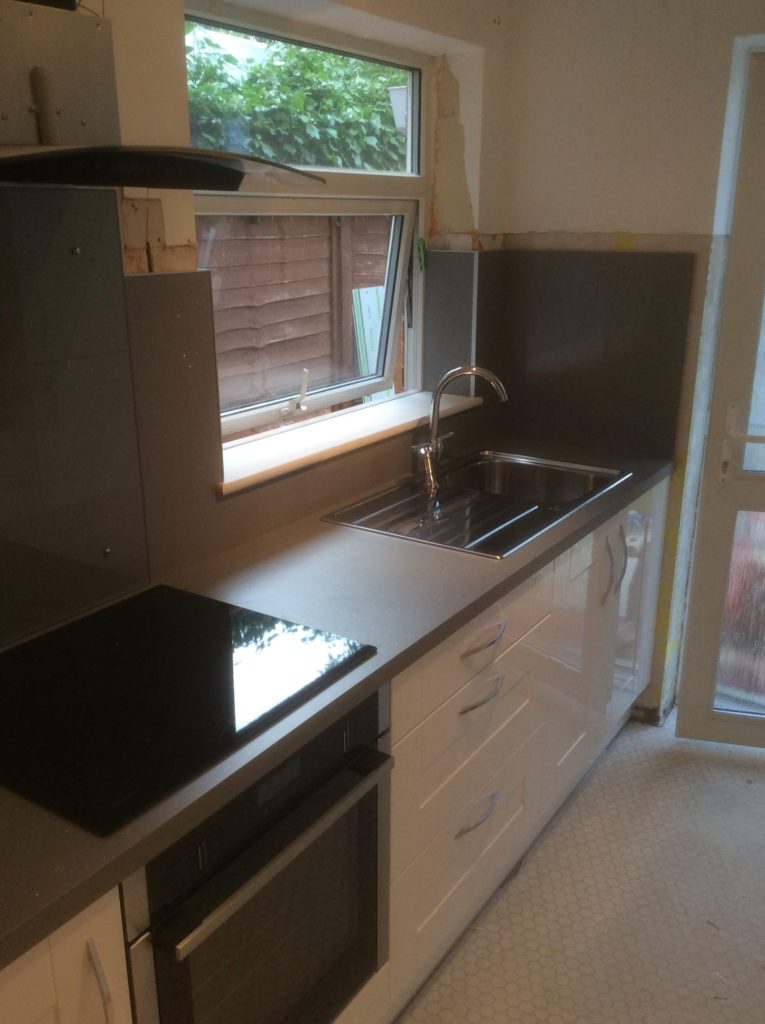 Kitchen with matching worktops & wall panels