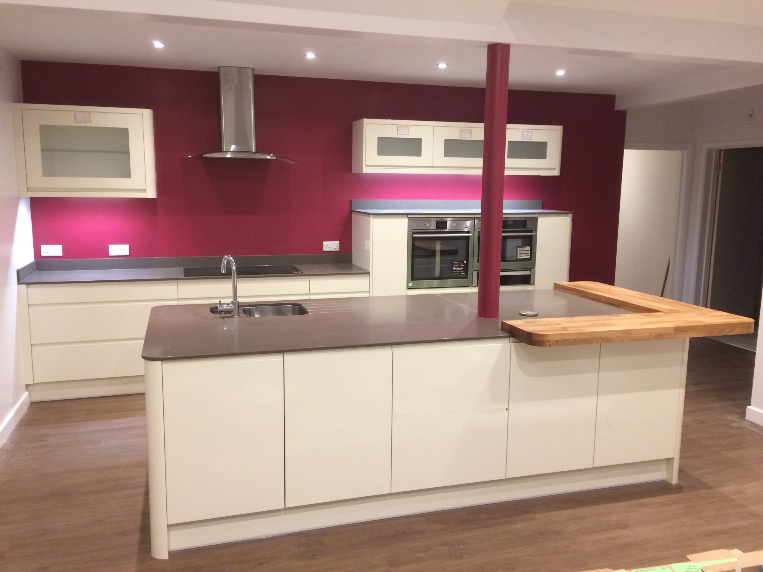 Maroon walls, cream units and kitchen island