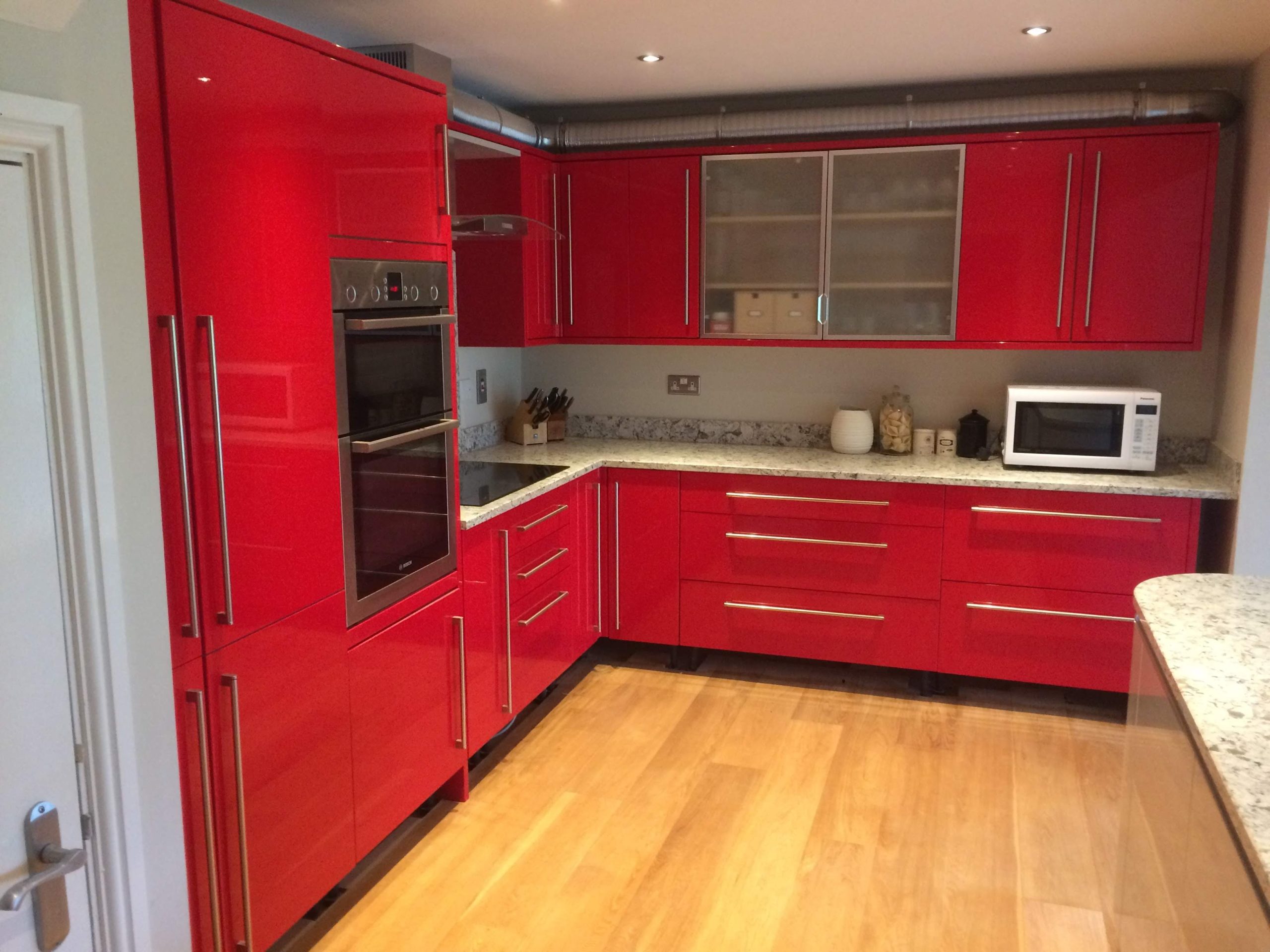 Red kitchen with white/fleck granite worktops
