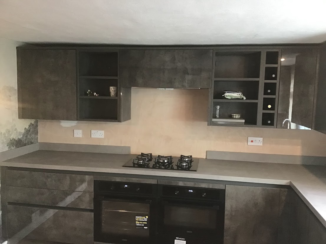 Dark grey kitchen units with single wine rack